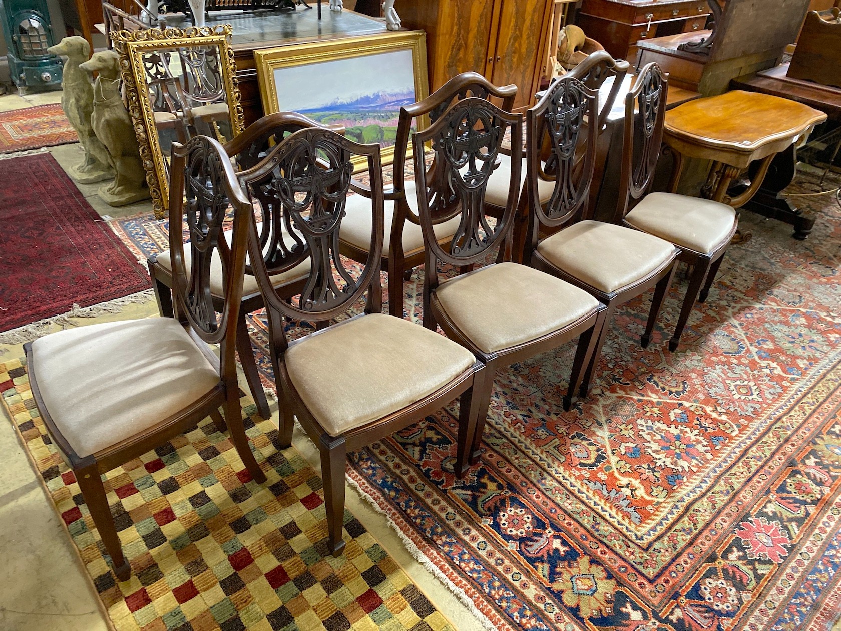 A set of eight early 20th century Hepplewhite style mahogany dining chairs (two with arms)
